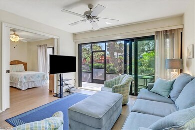 Living room featuring ceiling fan and wood finishe