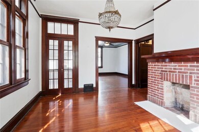 Formal dining room with exposed brick mantle