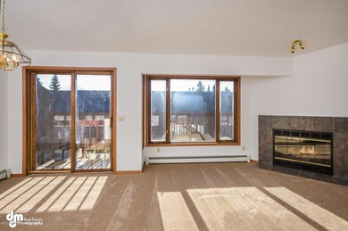 Living Rm w/Fireplace & Doors to Balcony