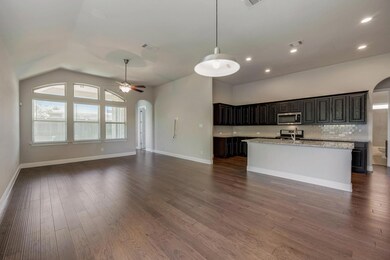 Kitchen with lofted ceiling, a kitchen island with