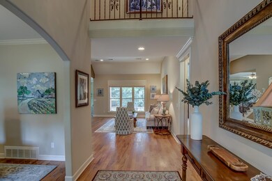 Entryway featuring ceiling fan and light wood-type
