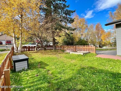 Level front lawn w/picket fence