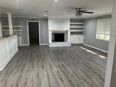 Unfurnished living room featuring ceiling fan, har