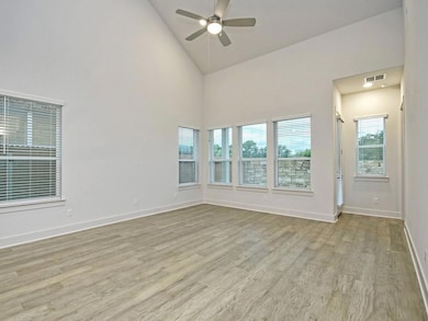 Spare room with wood finished floors, ceiling fan