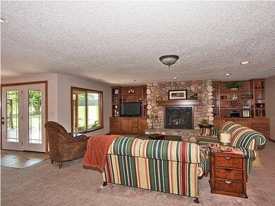 Beautiful Stone Fireplace and custom built bookshe