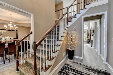 Stairway with crown molding, visible vents, wood f