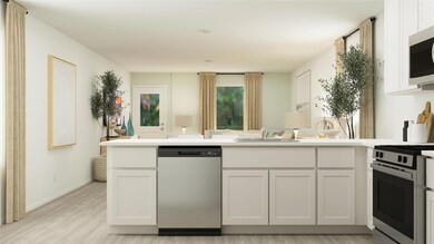 Kitchen with dishwasher, stove, white cabinetry, a