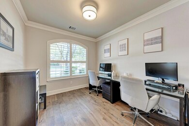 Home office featuring crown molding, wood finishe