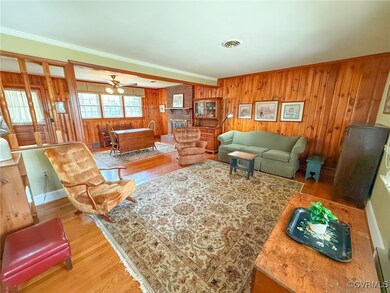 Living room with a fireplace, visible vents, crown