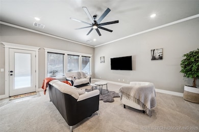 Open and airy living room with large windows overlooking the backyard, creating a warm and light-filled central gathering space