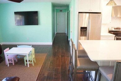 Hallway with LR and kitchen on either si