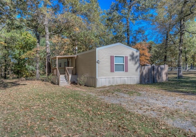 View of front of house with view of wooded area