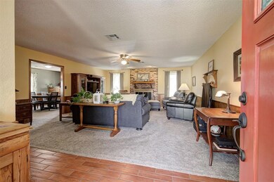 Spacious living room with a brick fireplace, light