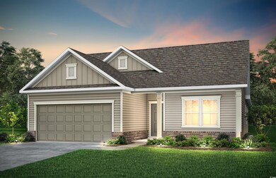 View of front of house with a garage and a lawn