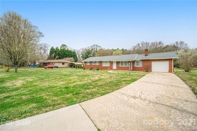 Large driveway in excellent condition leads to attached garage - which has a garage door on both sides!
