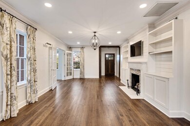 Unfurnished living room featuring dark wood-style 