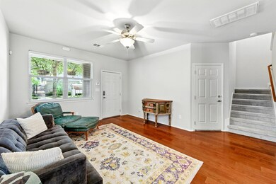 Living area featuring wood finished floors, a cei