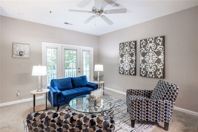 Carpeted living room with baseboards and ceiling f