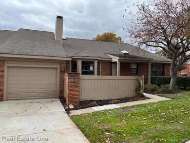 Ranch-style house with brick siding, roof with shingles, a chimney, driveway, and a garage