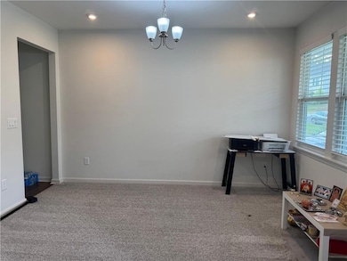 Office with plenty of natural light, carpet, a chandelier, and recessed lighting