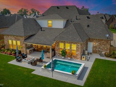 Pool at dusk featuring a fire pit, a lawn, and a p