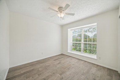 Bright secondary bedroom featuring stylish wood-lo