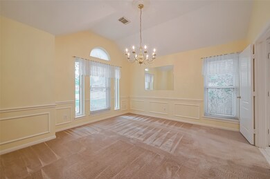This room features soft yellow walls with elegant