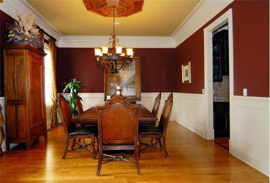 This beautiful dinig room has extensive molding and leads to the butlers pantry , which is off of the kitchen