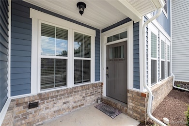 Doorway to property featuring covered porch