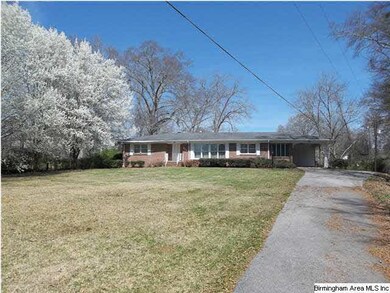 View from street with concrete drive to home.