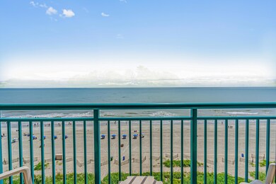 Balcony with a water view and a view of the beach