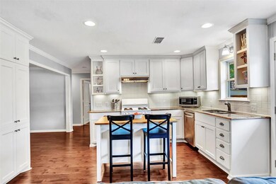Updated kitchen with white cabinets & backsplash, 