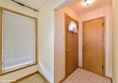Ceramic tile foyer with coat closet