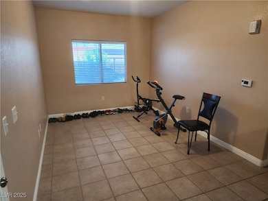 Workout room with light tile patterned floors and