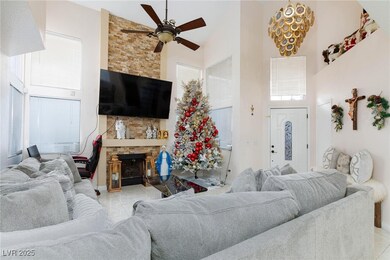 Living room with high vaulted ceiling, ceiling fan