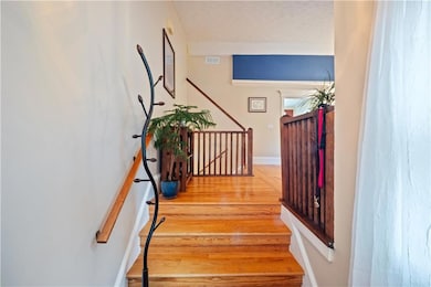 Stairs featuring wood finished floors and baseboar