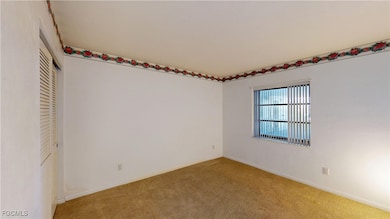 Unfurnished bedroom with carpet and a closet