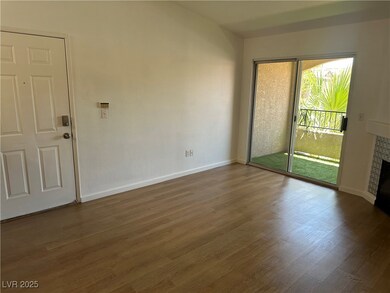 Empty room with a fireplace and wood finished floo