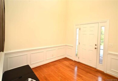 Soaring 2 Story foyer with hardwoods that extend t