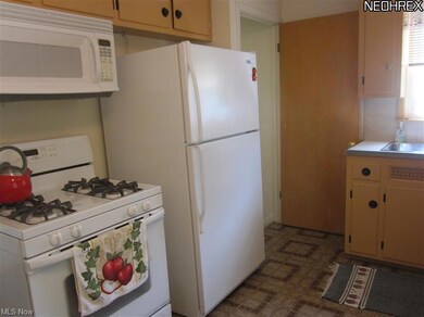 All newer appliances stay! Pretty natural wood cab