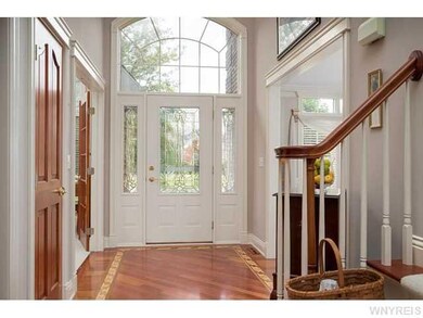 Foyer. Leaded glass front door and lots of transom