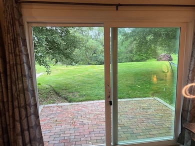 Slider to back patio overlooking the yard and pond