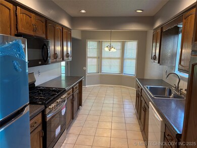 Kitchen with gas stove, freestanding refrigerator,