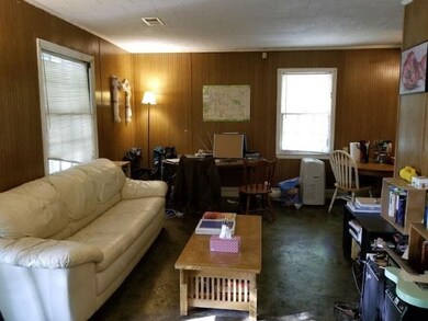 Open living/dining area with stained concrete floo