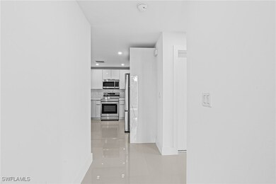 Hallway featuring baseboards, recessed lighting, l