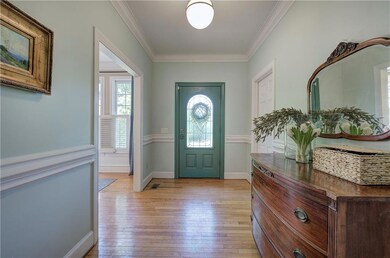 Foyer with light wood-style flooring, ornamental m