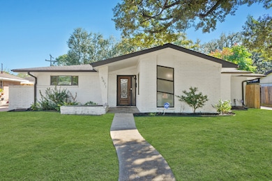 The Front Exterior Appeal is enhanced by the White Painted Brick Exterior, Pella Windows, Electronic Driveway Gate, & the Landscaped Front Yard.