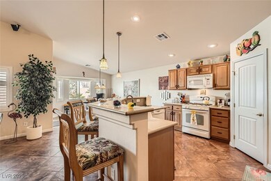 Kitchen featuring light countertops, hanging light