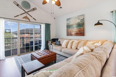 Living room with a ceiling fan, lofted ceiling, wo