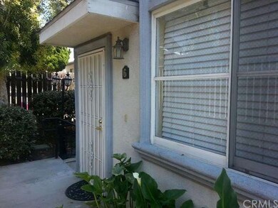 Front door with steps down to garage area. End uni